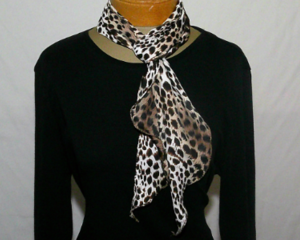 This picture shows the scarf being tied at the neck and draped.